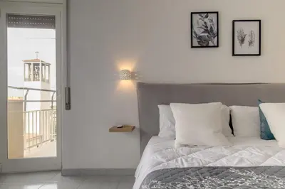 a bedroom with a bed with white pillows at Veroli Vacanze Romane in Rome
