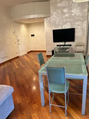 a blue table and chairs in a living room at Aurelia Antica Apartaments in Rome