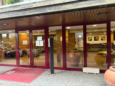 a store front with glass doors with a vase in it at Aurelia Antica Apartaments in Rome