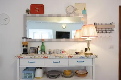 a dressing table with a lamp and a mirror at Perduta a Rome in Rome