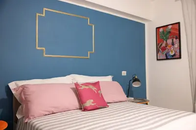 a bedroom with a bed with pink and blue walls at Perduta a Rome in Rome