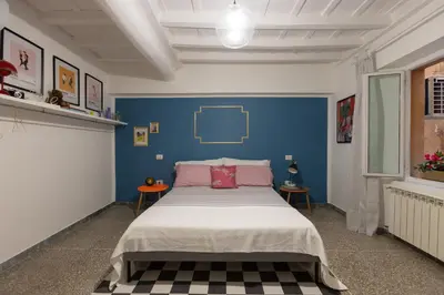 a bedroom with a bed with a blue wall at Perduta a Rome in Rome
