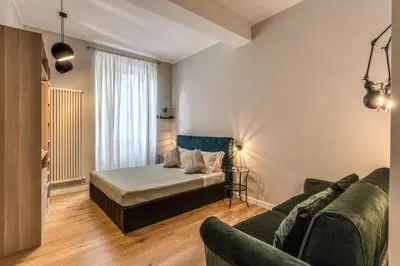 a living room with a bed and a couch at Fresh House Castel Sant' Angelo in Rome