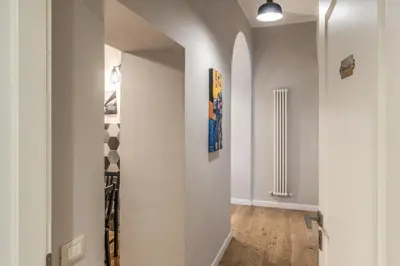 a hallway with white walls and an archway at Fresh House Castel Sant' Angelo in Rome
