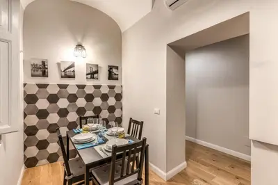 a dining room with a table and chairs at Fresh House Castel Sant' Angelo in Rome