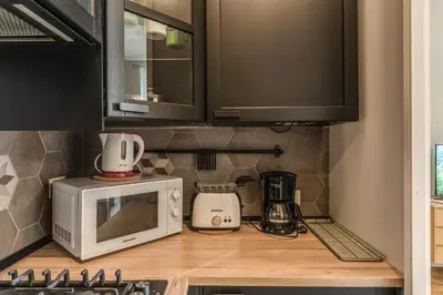 a kitchen with a microwave and a coffee maker on a counter at Fresh House Castel Sant' Angelo in Rome