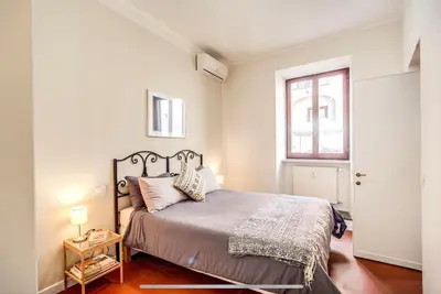 a bedroom with a large bed and a window at Coliseum cozy flat in Rome