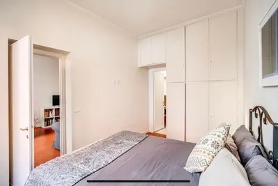 a bedroom with a bed and a couch at Coliseum cozy flat in Rome