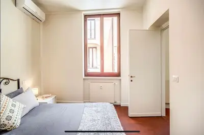 a bedroom with a large bed and a window at Coliseum cozy flat in Rome