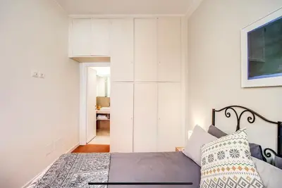 a bedroom with a bed and a white wall at Coliseum cozy flat in Rome