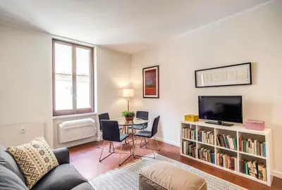 a living room with a couch and a tv and a table at Coliseum cozy flat in Rome