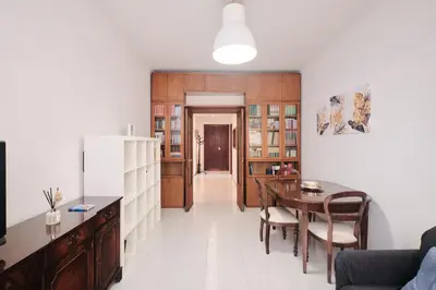 a living room with a table and a dining room at Parcheggio gratuito, Wi-Fi -Netflix & AC in Rome