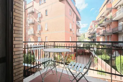 a balcony with a table and two chairs at Parcheggio gratuito, Wi-Fi -Netflix & AC in Rome