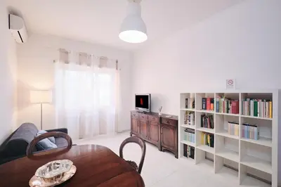 a living room with a couch and a table and a tv at Parcheggio gratuito, Wi-Fi -Netflix & AC in Rome