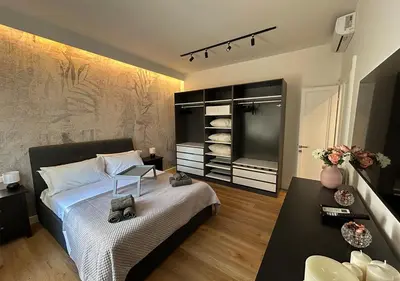 a bedroom with a bed and a tv and a table at Vatican Luxury Apartment in Rome