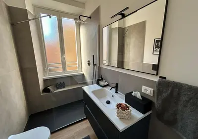 a bathroom with a sink and a mirror at Vatican Luxury Apartment in Rome