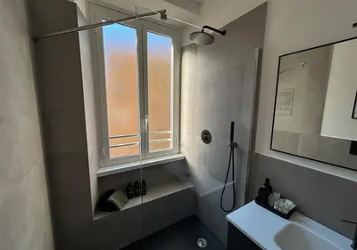 a bathroom with a shower and a sink and a window at Vatican Luxury Apartment in Rome