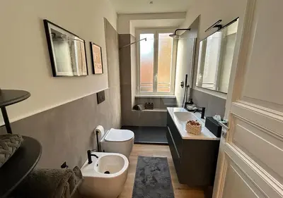 a bathroom with two sinks and a toilet and a sink at Vatican Luxury Apartment in Rome