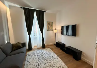 a living room with a couch and a large window at Vatican Luxury Apartment in Rome
