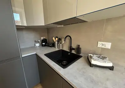 a kitchen with a sink and a counter top at Vatican Luxury Apartment in Rome