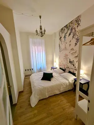 a bedroom with a bed and a chandelier at Suite 10 Parioli in Rome