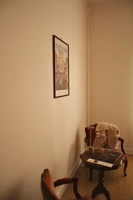 a living room with a table and a chair at Suite 10 Parioli in Rome