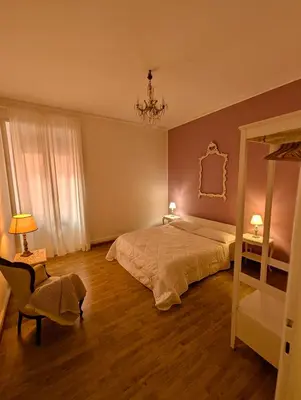 a bedroom with a bed and a mirror and a chair at Suite 10 Parioli in Rome