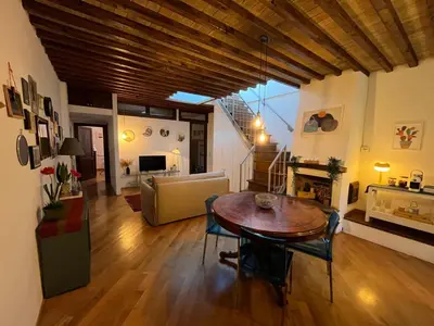a living room with a table and a couch at A Terrace With a View in Rome