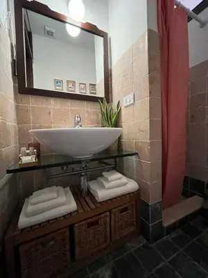 a bathroom with a sink and a mirror at A Terrace With a View in Rome