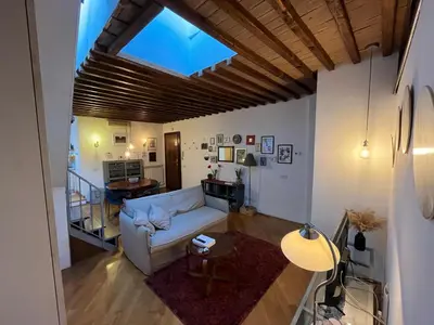 a living room with a couch and a table at A Terrace With a View in Rome