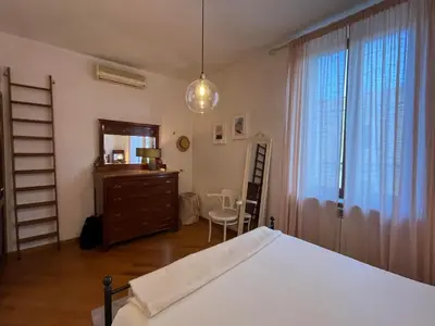 a bedroom with a bed and a dresser and a window at A Terrace With a View in Rome