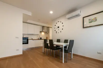 a kitchen and dining room with a table and chairs at Piazza Lodi - Apartment in Rome