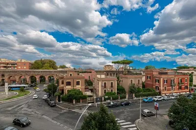 a city with cars parked in a parking lot at Piazza Lodi - Apartment in Rome