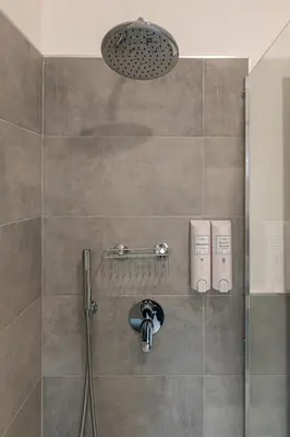 a shower with a shower head in a bathroom at Piazza Lodi - Apartment in Rome