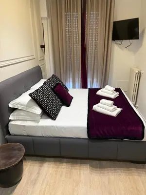 a bed with towels and pillows on it in a room at XCross Suites Basilica San Paolo in Rome