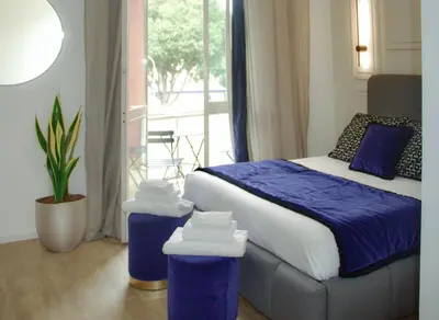 a bedroom with a bed and two trash cans at XCross Suites Basilica San Paolo in Rome