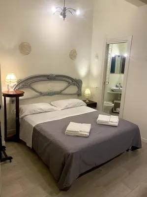 a bedroom with a bed with two towels on it at Secret Garden in Rome in Rome
