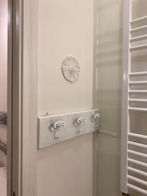a bathroom with two faucets on a wall at Secret Garden in Rome in Rome