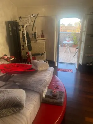 a room with a machine in a room with a patio at Ave Roma Suite in Rome