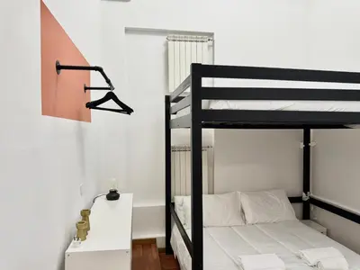 a bedroom with a bunk bed and a desk and a bunk bed at Boutique Trevi Apartment in Rome