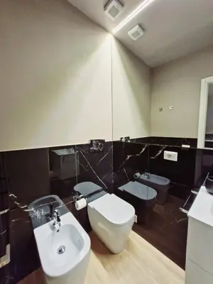 a bathroom with a white toilet and a sink at Vatican Charme&Chic in Rome