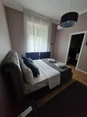 a bedroom with a large bed and a window at Vatican Charme&Chic in Rome