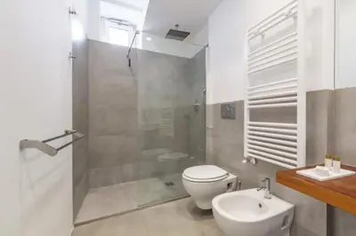 a bathroom with a shower and a toilet and a sink at Great Opera a Via Palermo in Rome