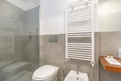 a bathroom with a toilet and a shower and a sink at Great Opera a Via Palermo in Rome