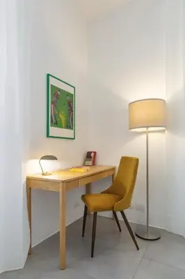 a desk with a chair and a lamp in a room at Great Opera a Via Palermo in Rome