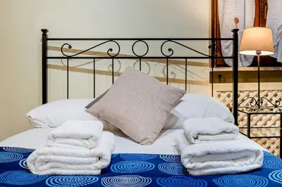 a bed with towels sitting on top of it at Domus Antica Navona in Rome