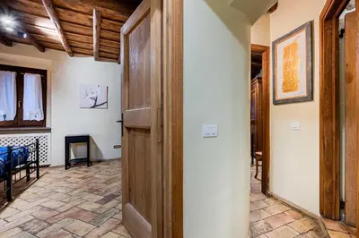 a hallway with a wooden door and a room at Domus Antica Navona in Rome
