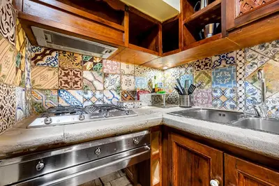 a kitchen with a sink and a stove at Domus Antica Navona in Rome