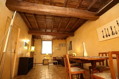 a living room with a wooden ceiling and a table at Domus Antica Navona in Rome