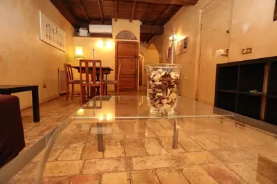 a glass table with a vase on top of it at Domus Antica Navona in Rome